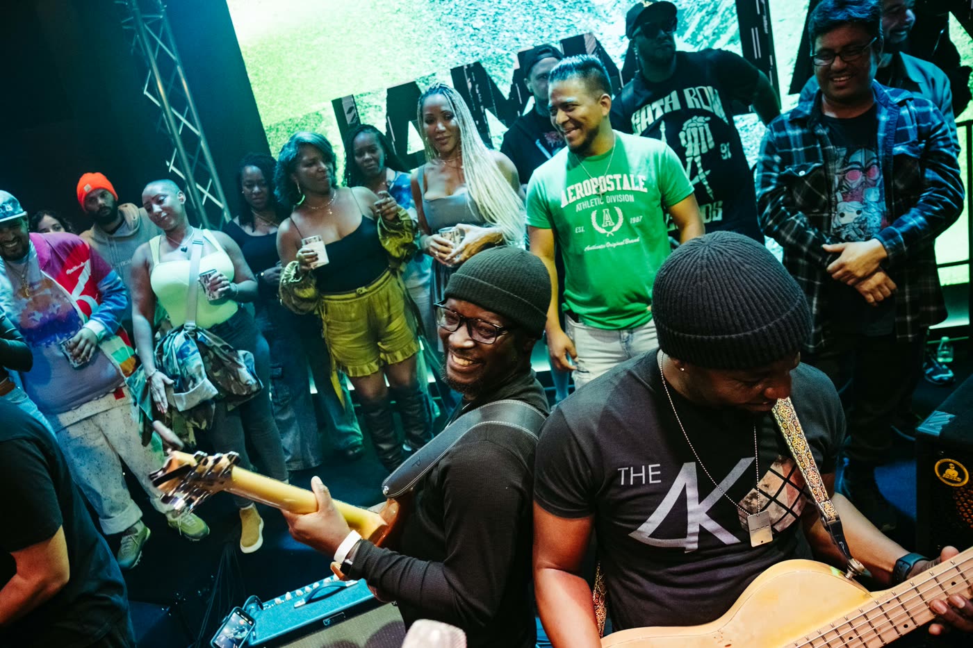 Players on the Live Room stage with the room packed shoulder to shoulder behind them.